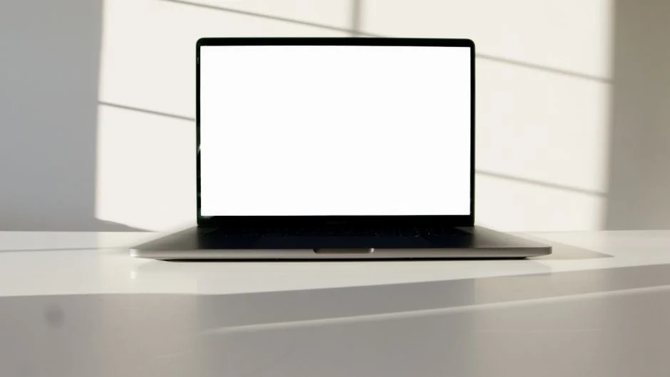 A stylish workspace featuring a laptop and monitors displaying design software.